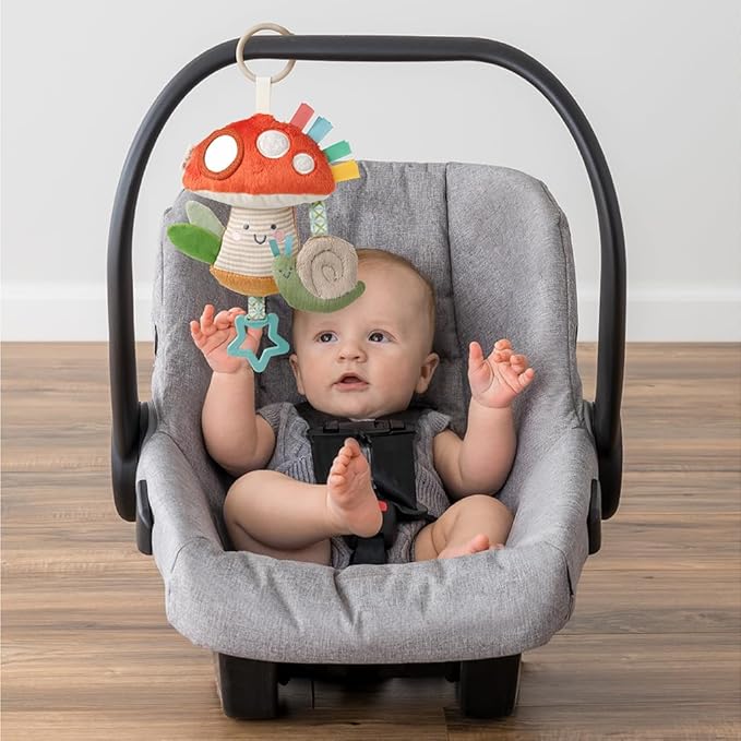 Itzy Ritzy Bitzy Traveler Car Seat & Stroller Toy for Babies – Developmental Sensory Toy Features Crinkle & Rattle Sounds & Multiple Textures –Hanging Travel Toy for On-the-Go Entertainment (Mushroom)
